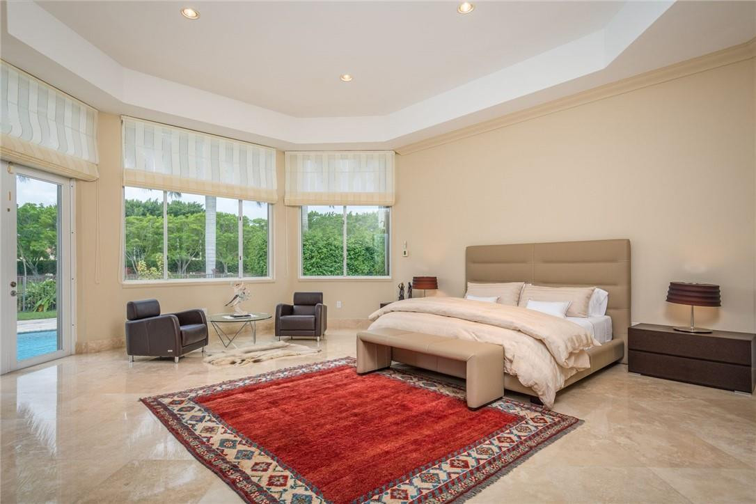 3620 Paddock Road Weston, FL 33331 - Photo 20 of 51 a bedroom with a large bed and a large window