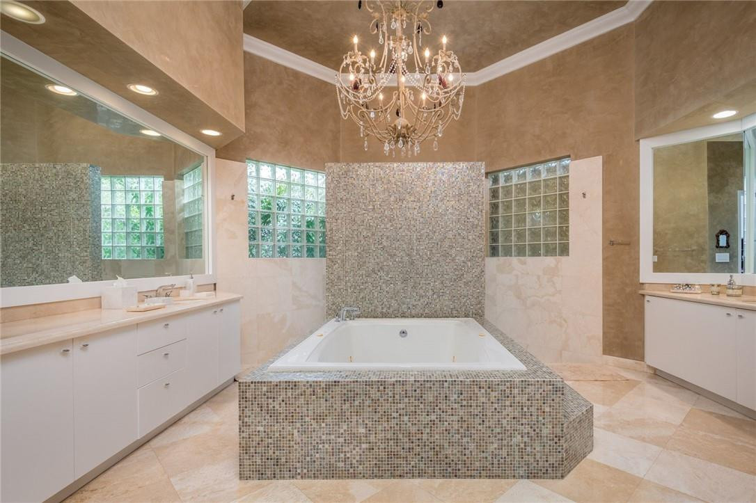 3620 Paddock Road Weston, FL 33331 - Photo 21 of 51 a spacious bathroom with a granite countertop sink a large mirror and a bathtub