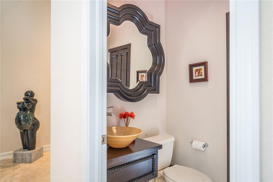 3620 Paddock Road Weston, FL 33331 - Photo 25 of 51 a bathroom with a toilet a sink and mirror