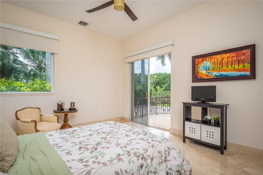 3620 Paddock Road Weston, FL 33331 - Photo 29 of 51 a bedroom with a bed and a flat tv screen on the dresser
