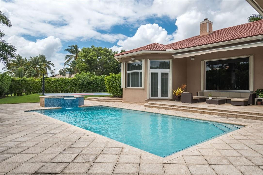 3620 Paddock Road Weston, FL 33331 - Photo 35 of 51 a view of a house with sitting area and swimming pool