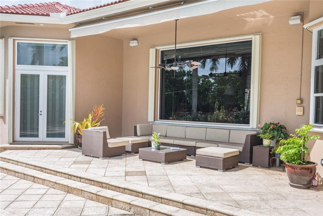 3620 Paddock Road Weston, FL 33331 - Photo 41 of 51 a living room with patio furniture and potted plants