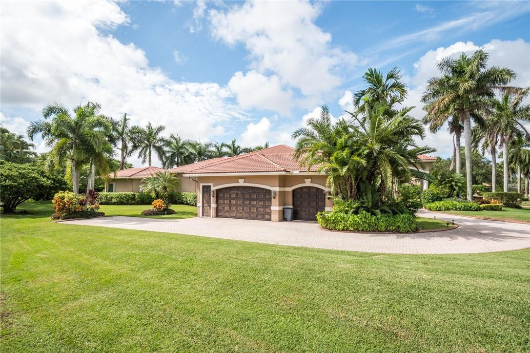 3620 Paddock Road Weston, FL 33331 - Photo 47 of 51 a front view of house with yard and green space