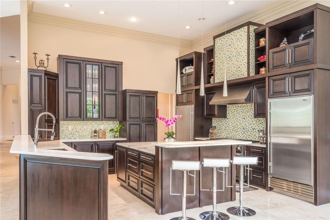 3620 Paddock Road Weston, FL 33331 - Photo 8 of 51 a kitchen with stainless steel appliances granite countertop a refrigerator and a stove top oven