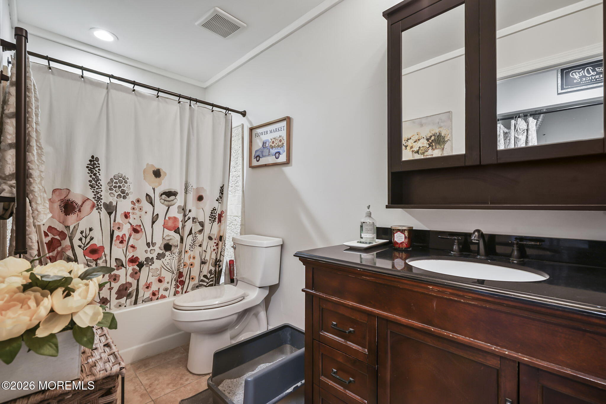 402 Daisy Court Jackson, NJ 08527 - Photo 13 of 16 a bathroom with a sink a toilet and shower curtain