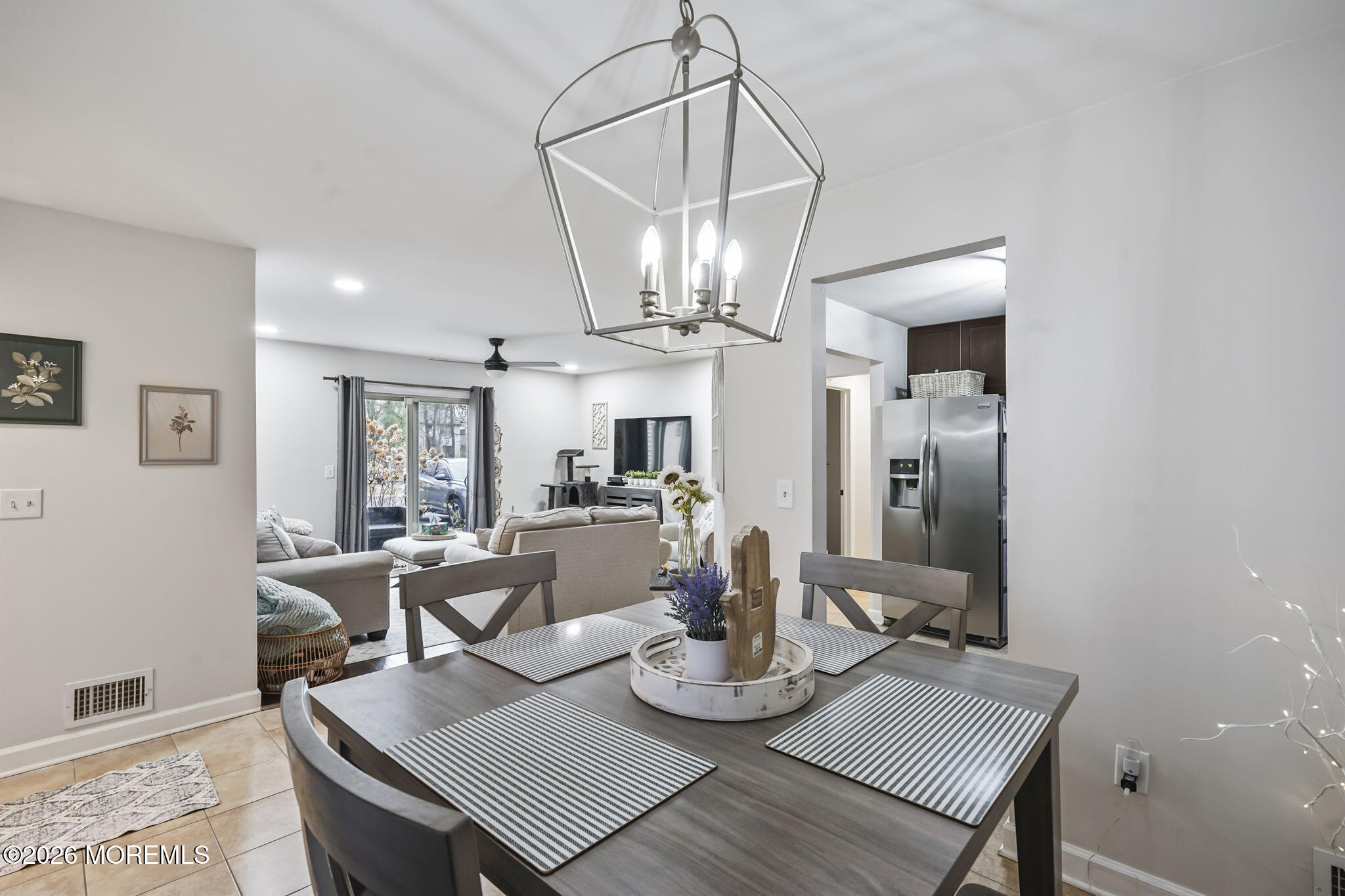 402 Daisy Court Jackson, NJ 08527 - Photo 9 of 16 a view of a dining room with furniture a chandelier and wooden floor