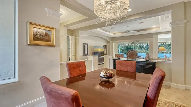 a kitchen with stainless steel appliances granite countertop a refrigerator a sink dishwasher and white cabinets with wooden floor