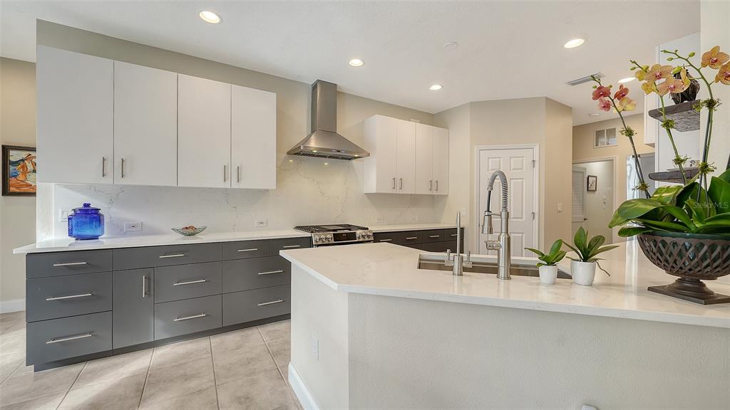 4855 Carrington Circle Sarasota, FL 34243 - Photo 14 of 58 a kitchen with stainless steel appliances granite countertop a sink and a white cabinets