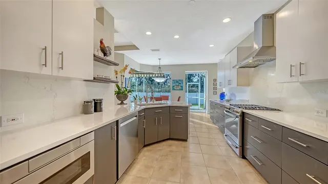 a living room with kitchen island furniture and a chandelier