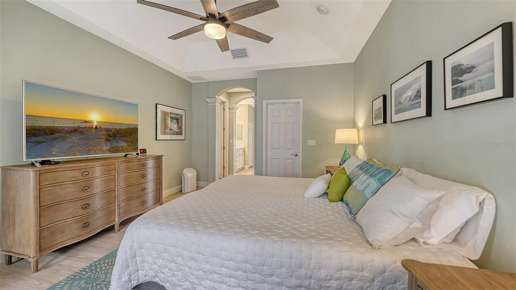 4855 Carrington Circle Sarasota, FL 34243 - Photo 26 of 58 a bedroom with a bed and a flat screen tv
