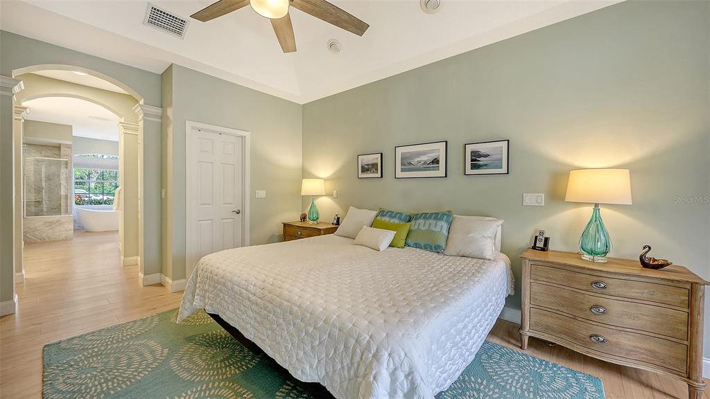 4855 Carrington Circle Sarasota, FL 34243 - Photo 27 of 58 a bedroom with a bed and a lamp