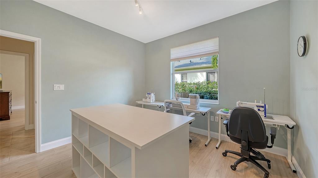 4855 Carrington Circle Sarasota, FL 34243 - Photo 35 of 58 a view of a workspace with furniture and a window