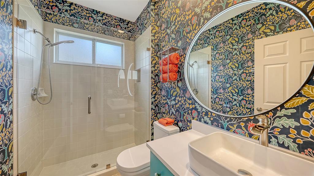 4855 Carrington Circle Sarasota, FL 34243 - Photo 37 of 58 a bathroom with a toilet sink and shower
