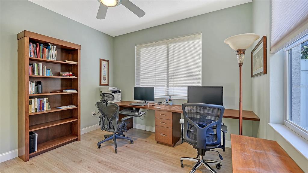 4855 Carrington Circle Sarasota, FL 34243 - Photo 39 of 58 a view of a workspace with furniture and a bookshelf