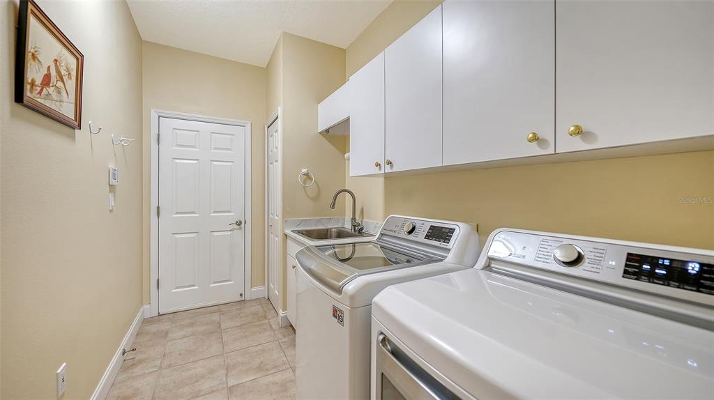 4855 Carrington Circle Sarasota, FL 34243 - Photo 41 of 58 a utility room with dryer and washer