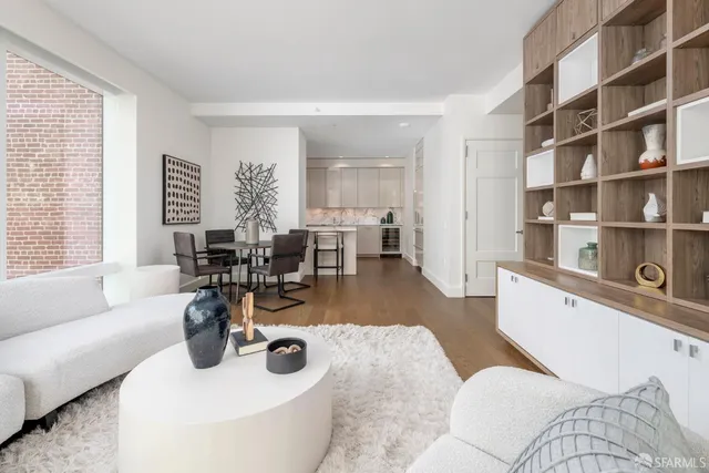 a bedroom with furniture and a large window