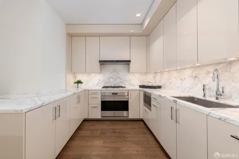 a bathroom with a double vanity sink mirror and shower