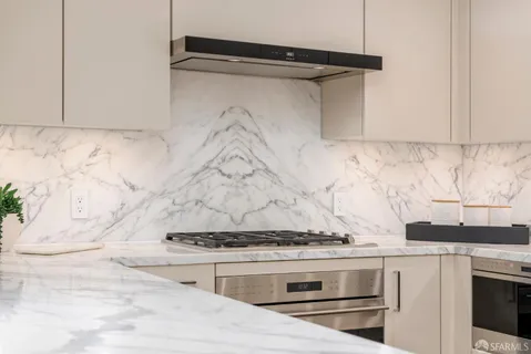 a bathroom with a granite countertop sink mirror vanity and toilet