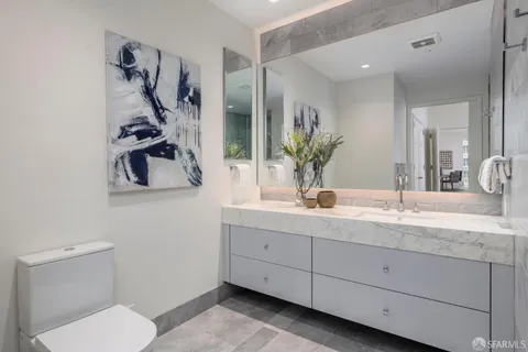 a bathroom with a glass door shower and a sink