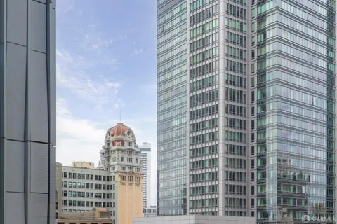 a living room with stainless steel appliances granite countertop furniture and a large window