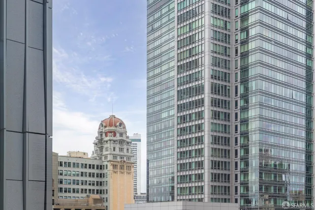 a living room with stainless steel appliances granite countertop furniture and a large window
