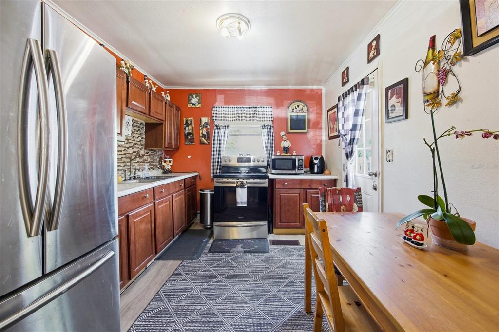 10535 3rd Avenue Ocoee, FL 34761 - Photo 4 of 22 a kitchen with stainless steel appliances granite countertop a refrigerator a stove and a sink