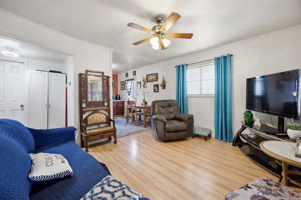 10535 3rd Avenue Ocoee, FL 34761 - Photo 6 of 22 a living room with furniture ceiling fan and a rug