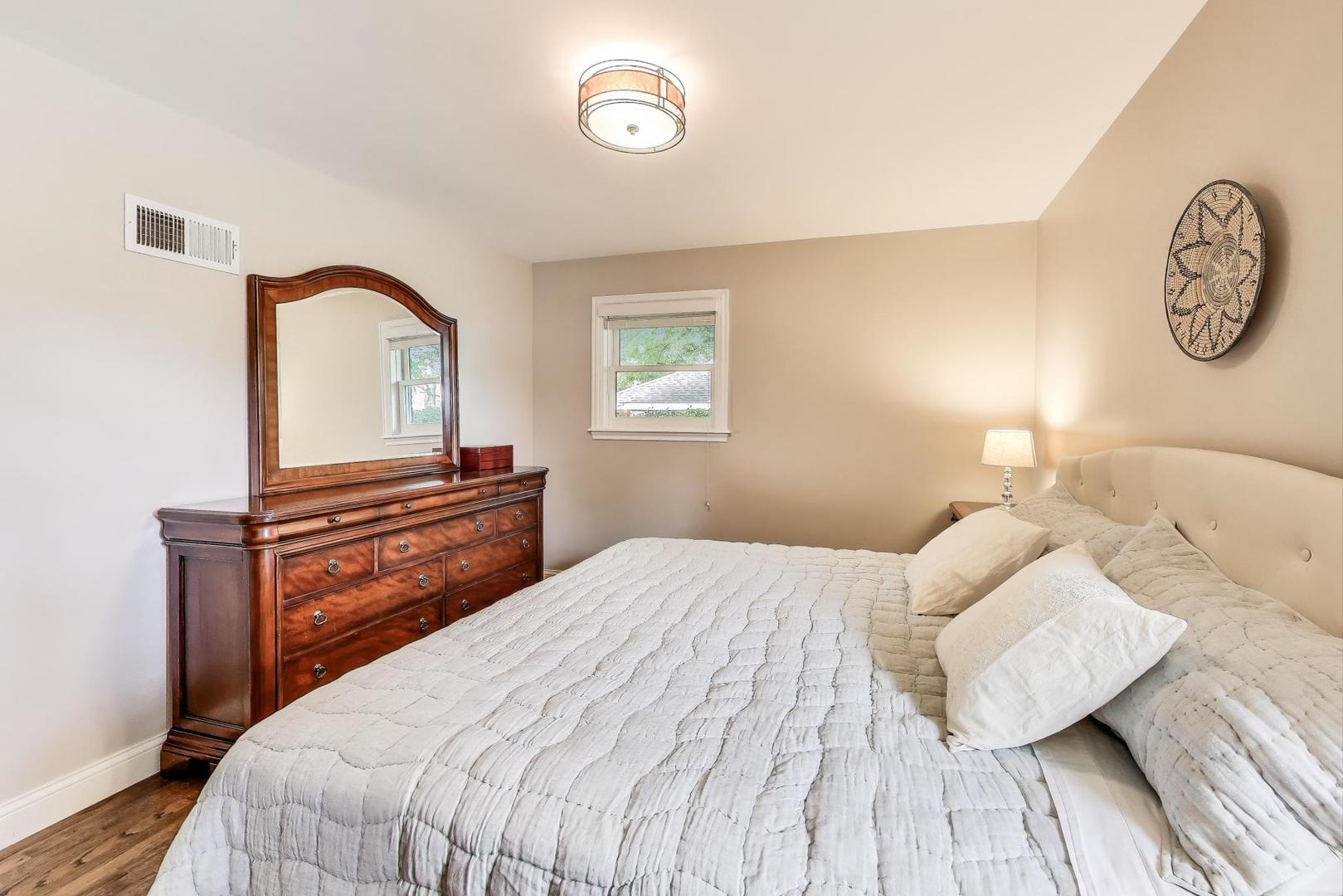 1000 East Lincoln Street Mount Prospect, IL 60056 - Photo 15 of 37 a bedroom with a bed and a closet with wooden floor