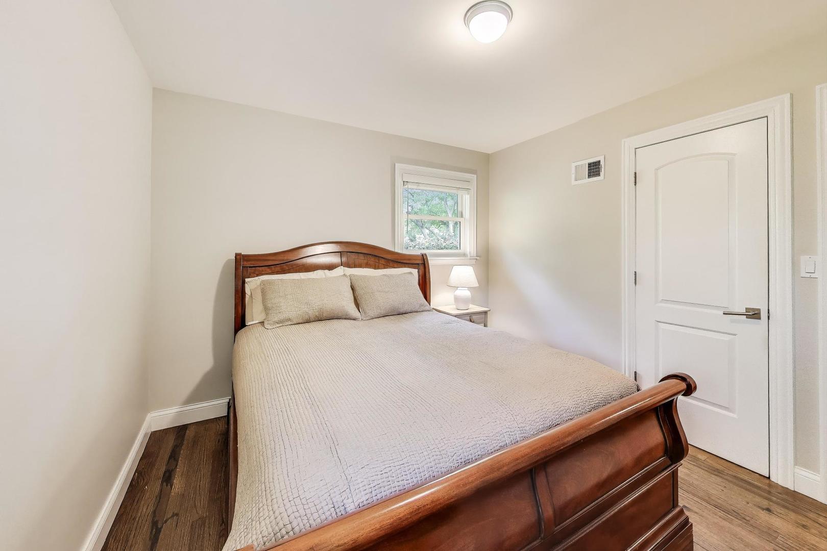 1000 East Lincoln Street Mount Prospect, IL 60056 - Photo 17 of 37 a bedroom with a bed and wooden floor