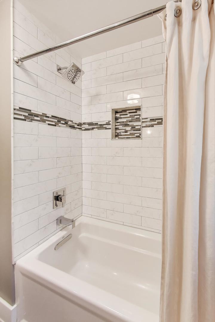 1000 East Lincoln Street Mount Prospect, IL 60056 - Photo 19 of 37 a bathroom with a bathtub and shower