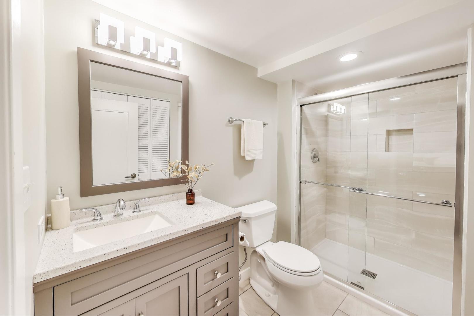 1000 East Lincoln Street Mount Prospect, IL 60056 - Photo 25 of 37 a bathroom with a granite countertop sink toilet and shower