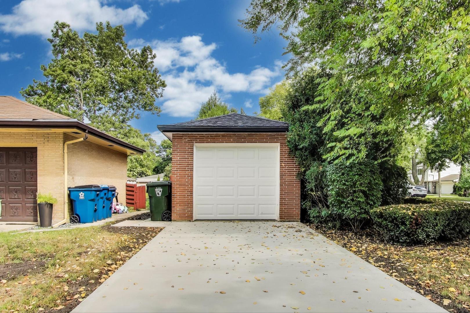 1000 East Lincoln Street Mount Prospect, IL 60056 - Photo 35 of 37 a front view of a house with a yard and garage
