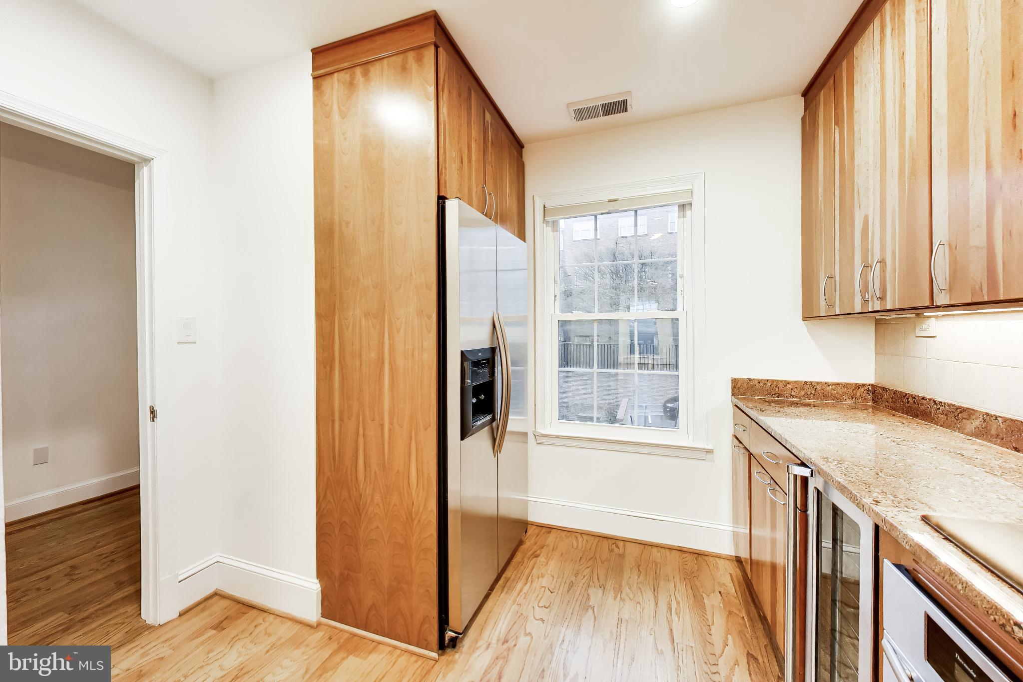 1660 Beekman Place Northwest, Unit A Washington, DC 20009 - Photo 11 of 24 Modern kitchen with warm wood accents.