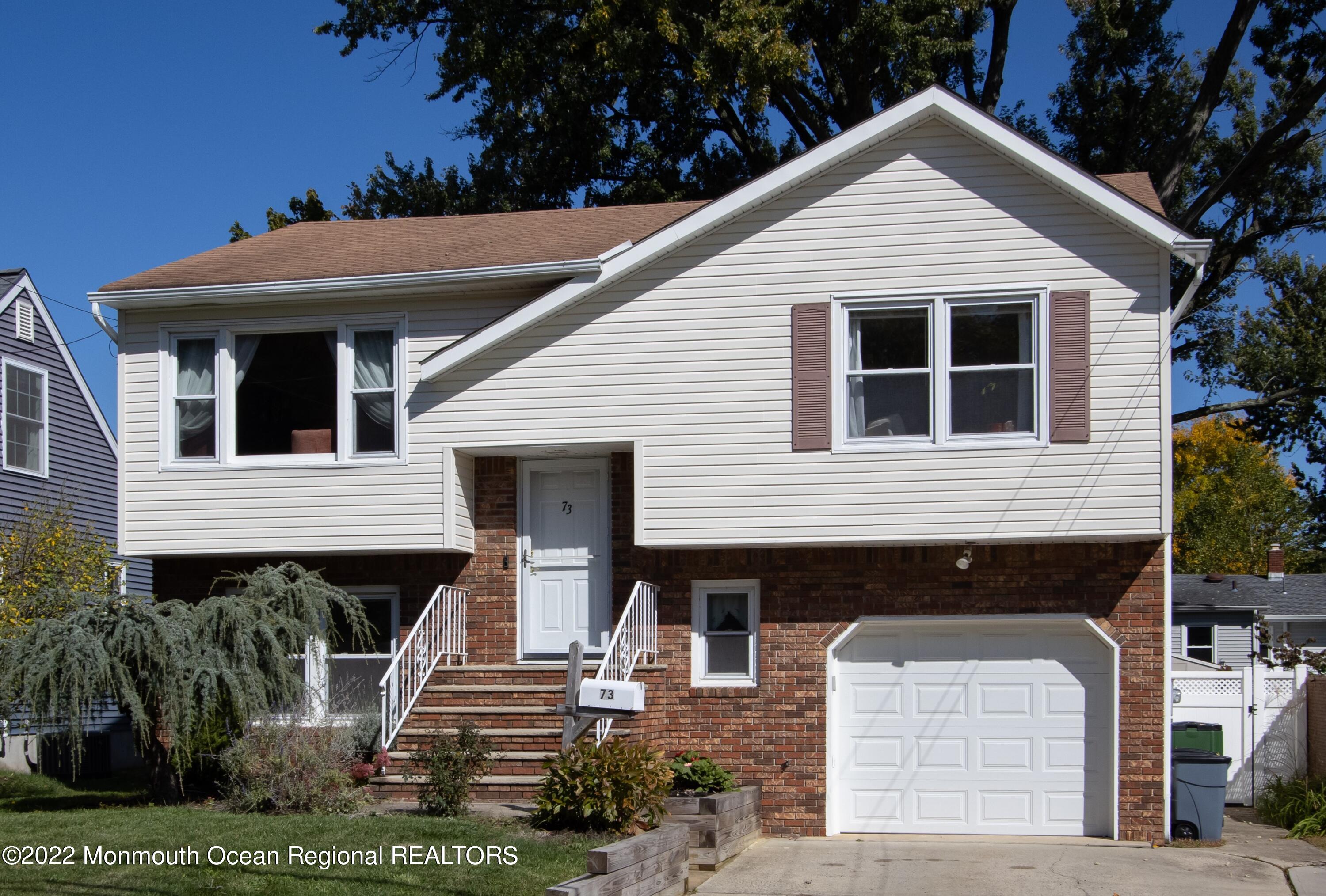 73 Ravine Drive Matawan, NJ 07747 - Photo 1 of 15 a front view of a house with garden