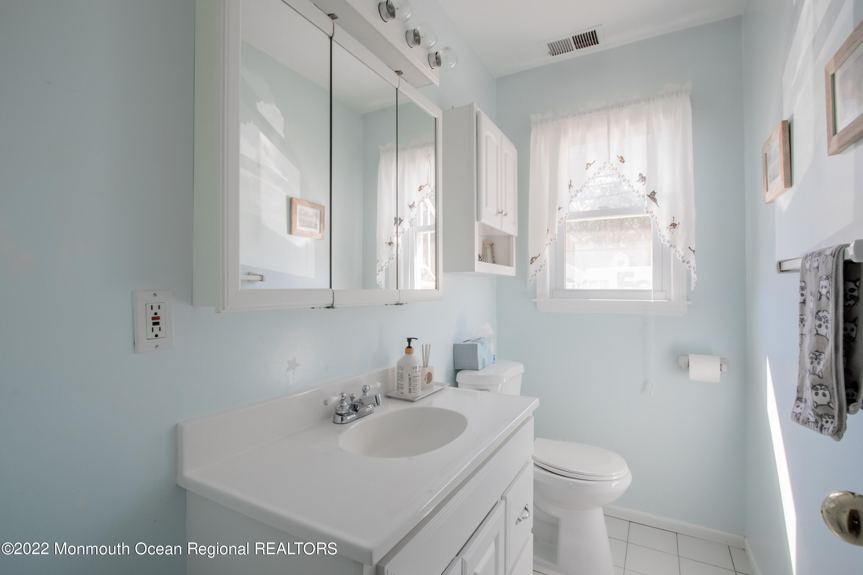 73 Ravine Drive Matawan, NJ 07747 - Photo 14 of 15 a bathroom with a sink toilet and mirror