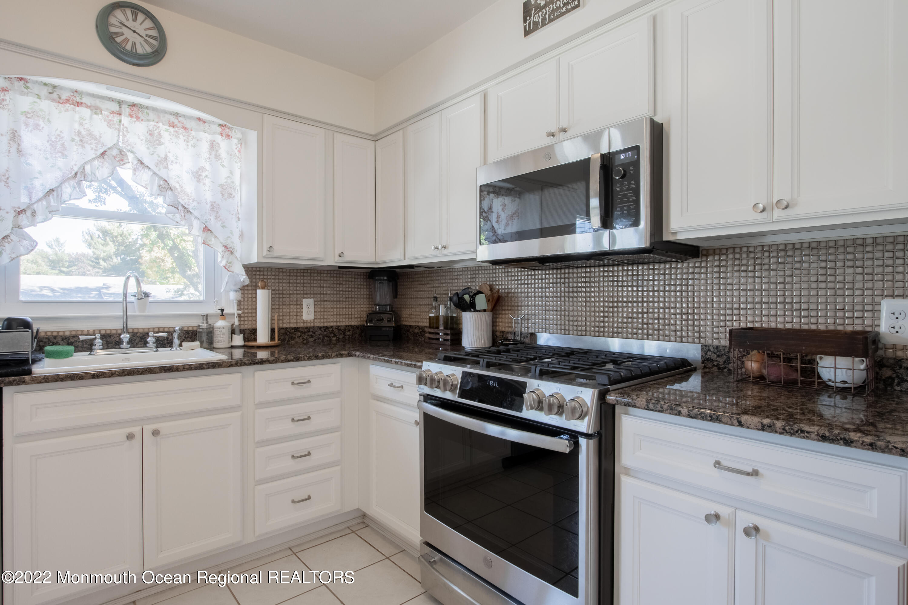 73 Ravine Drive Matawan, NJ 07747 - Photo 8 of 15 a kitchen with granite countertop white cabinets appliances and a window