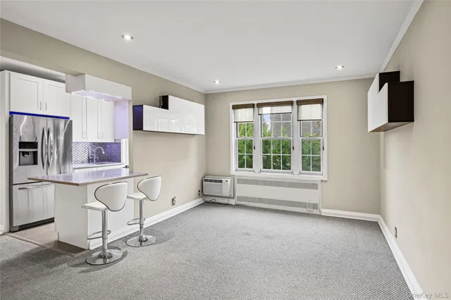 a view of kitchen with furniture and windows