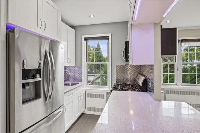 a kitchen with a refrigerator and a window
