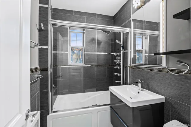 a bathroom with a sink mirror toilet and bathtub