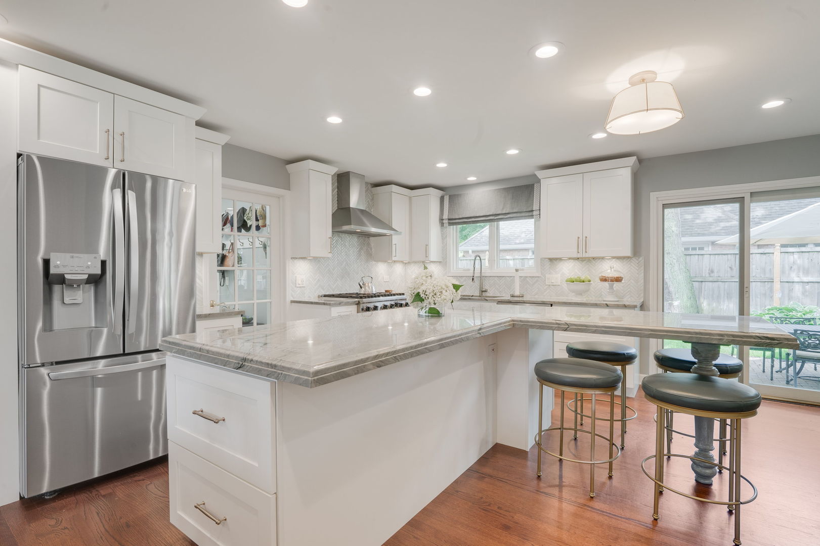 2022 Brandon Road Glenview, IL 60025 - Photo 11 of 35 a kitchen with stainless steel appliances granite countertop a sink a stove a refrigerator and island with wooden floor