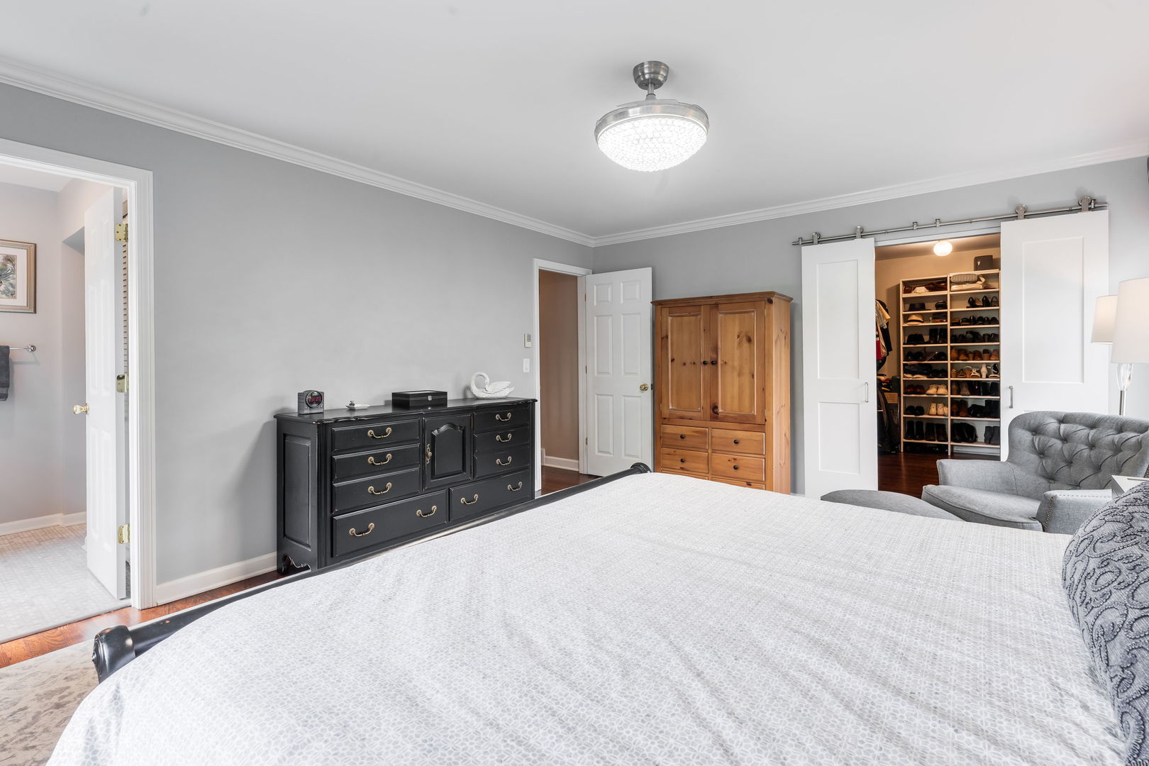 2022 Brandon Road Glenview, IL 60025 - Photo 21 of 35 a bedroom with a bed and dresser with mirror