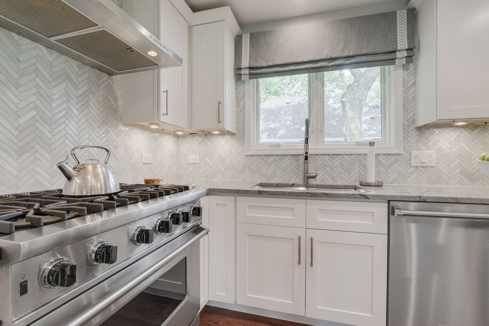 2022 Brandon Road Glenview, IL 60025 - Photo 7 of 35 a kitchen with stainless steel appliances granite countertop white cabinets and a stove top oven