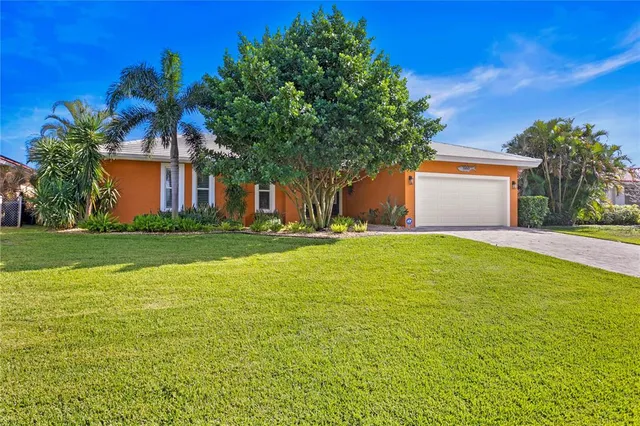 a front view of house with yard and trees in the background