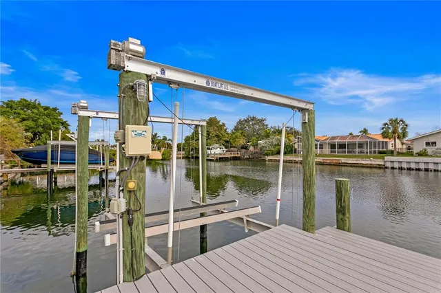 a dining hall with stainless steel appliances granite countertop a sink a dining table and chairs