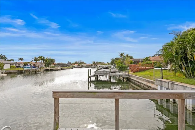 a large kitchen with sink and a refrigerator