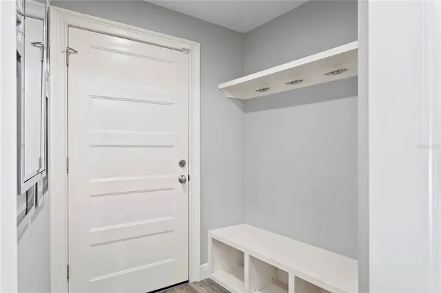 a view of living room with a large window and front door