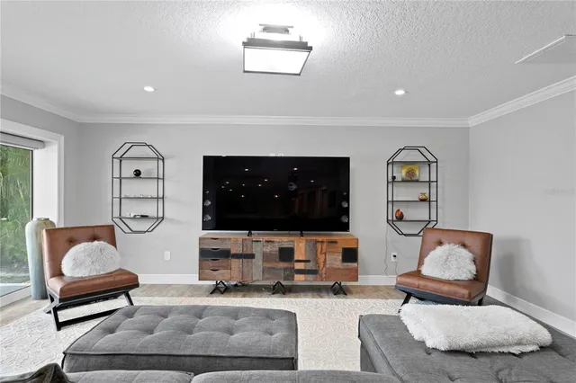 a bedroom with a bed and a flat screen tv on the dresser