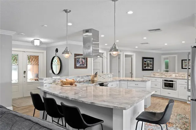 a bathroom with a granite countertop sink mirror and shower