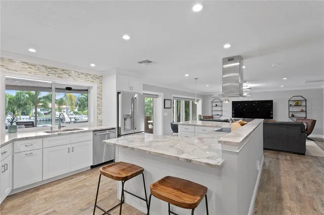 a bedroom with a bed and a dresser next to a window