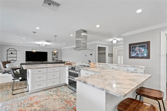 a view of a dining room with furniture and a chandelier